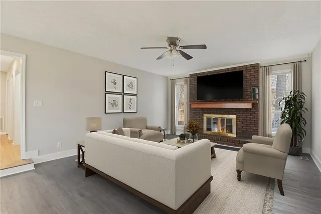 a living room with furniture a fireplace and a flat screen tv