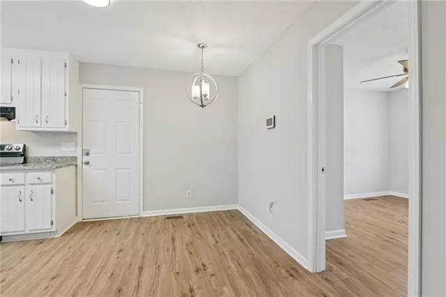 a view of a kitchen with wooden floor and a window