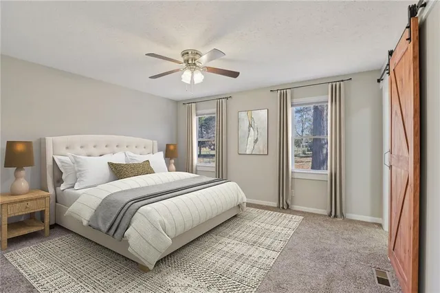 a bedroom with a large bed and a chandelier