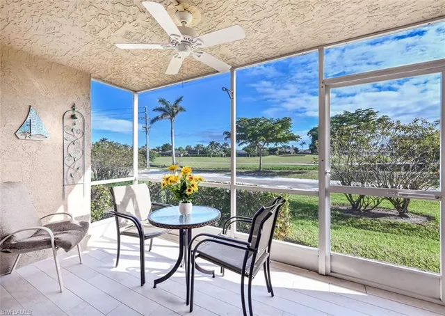 a view of a porch with chairs and backyard