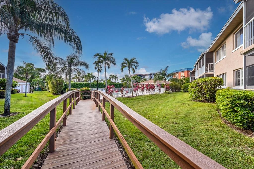 240 Pebble Beach Boulevard, Unit 702 Naples, FL 34113 - Photo 21 of 25 Walkway to Community Pool