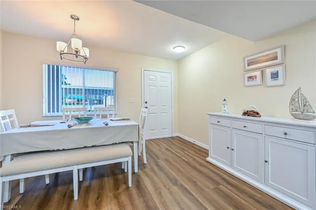 a kitchen with granite countertop white cabinets and window