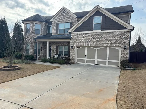 a front view of a house with garage