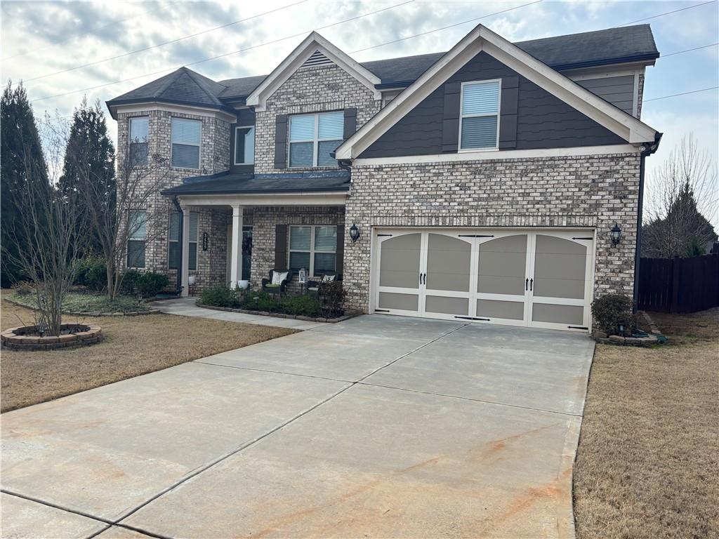 3459 In Bloom Way Auburn, GA 30011 - Photo 1 of 35 a front view of a house with garage