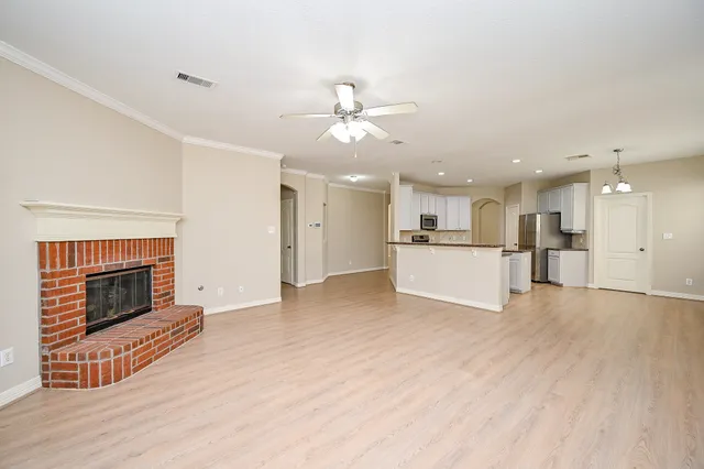 a view of a kitchen with a sink and a fireplace