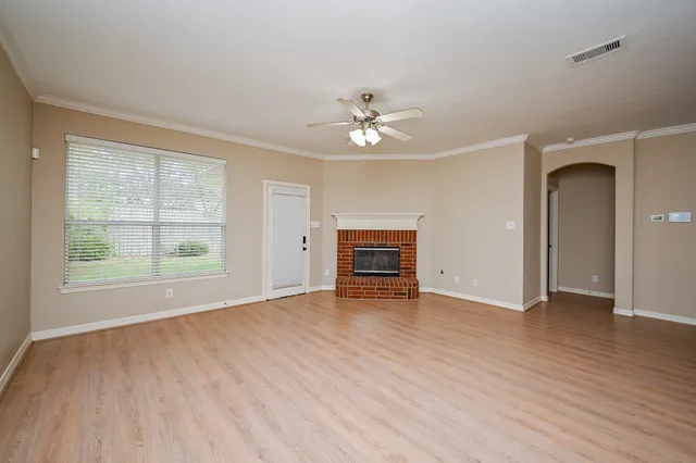 wooden floor in an empty room with a window