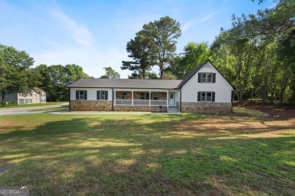 a front view of a house with a yard