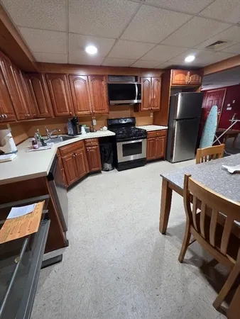 a kitchen with sink a microwave and refrigerator