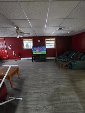 a view of water heater room with wooden floor