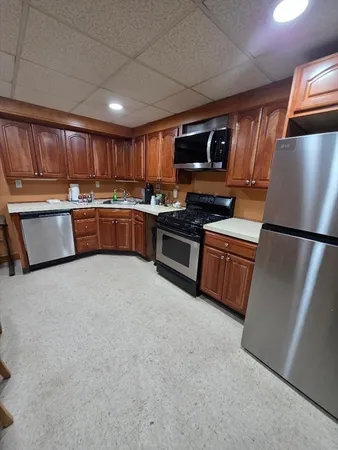 a bathroom with a granite countertop sink a toilet and a mirror