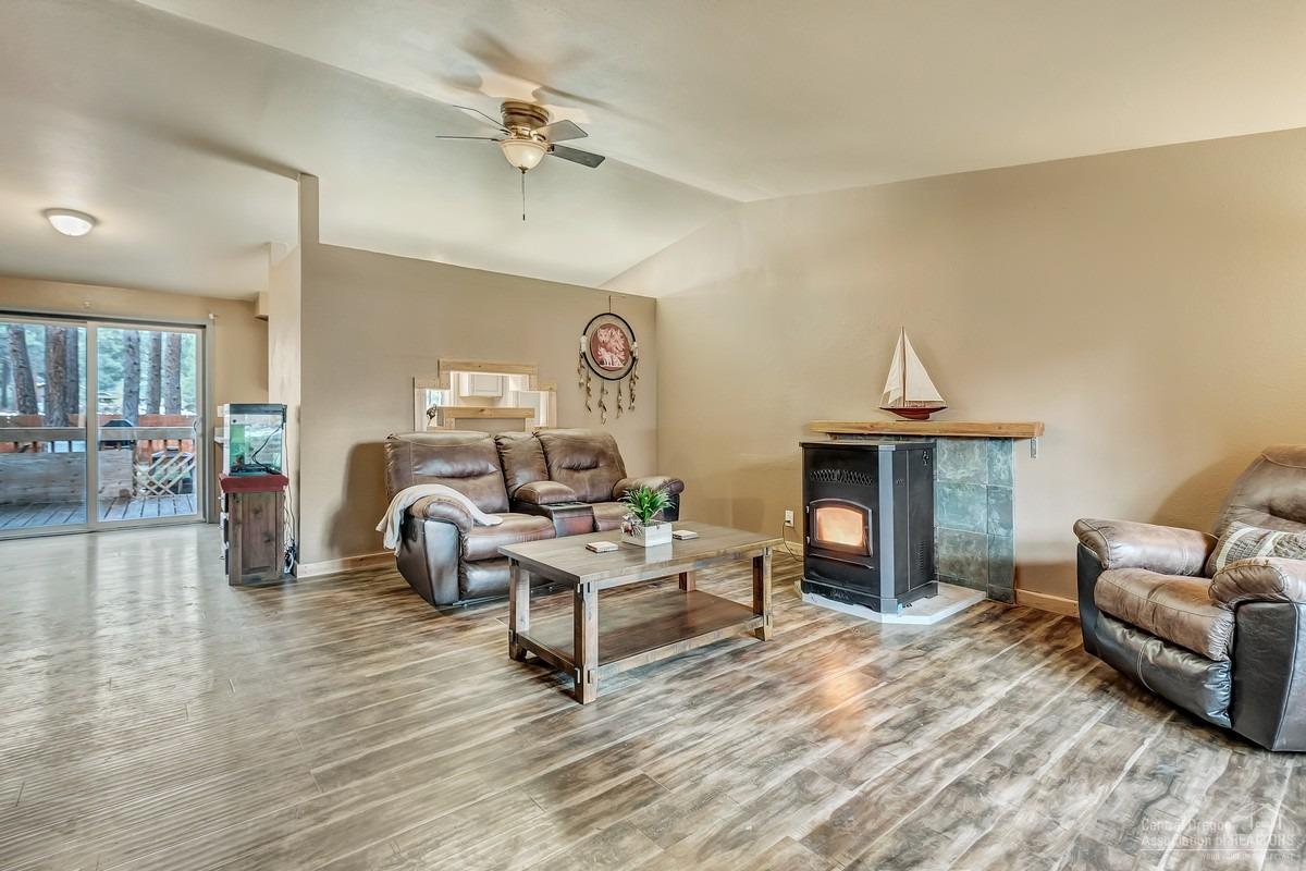 59757 Cheyenne Road Bend, OR 97702 - Photo 4 of 25 a living room with furniture and a wooden floor