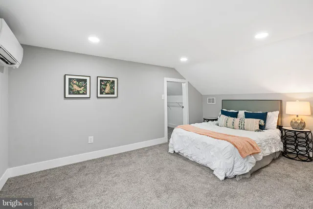 a bedroom with a bed and a painting