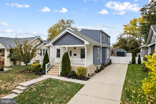 a front view of a house with a garden and plants