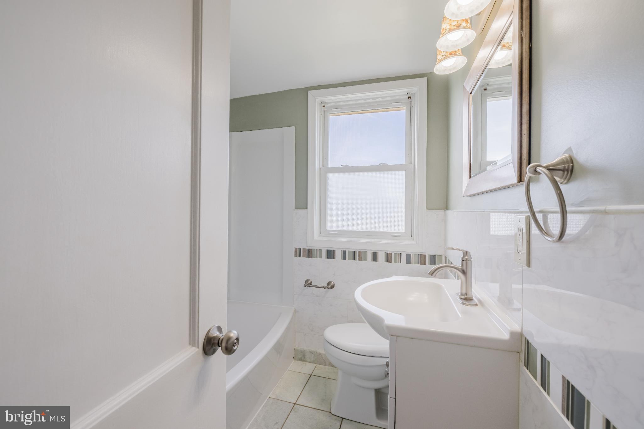 1636 Thetford Road Baltimore, MD 21286 - Photo 13 of 23 a bathroom with a sink a toilet and a bathtub