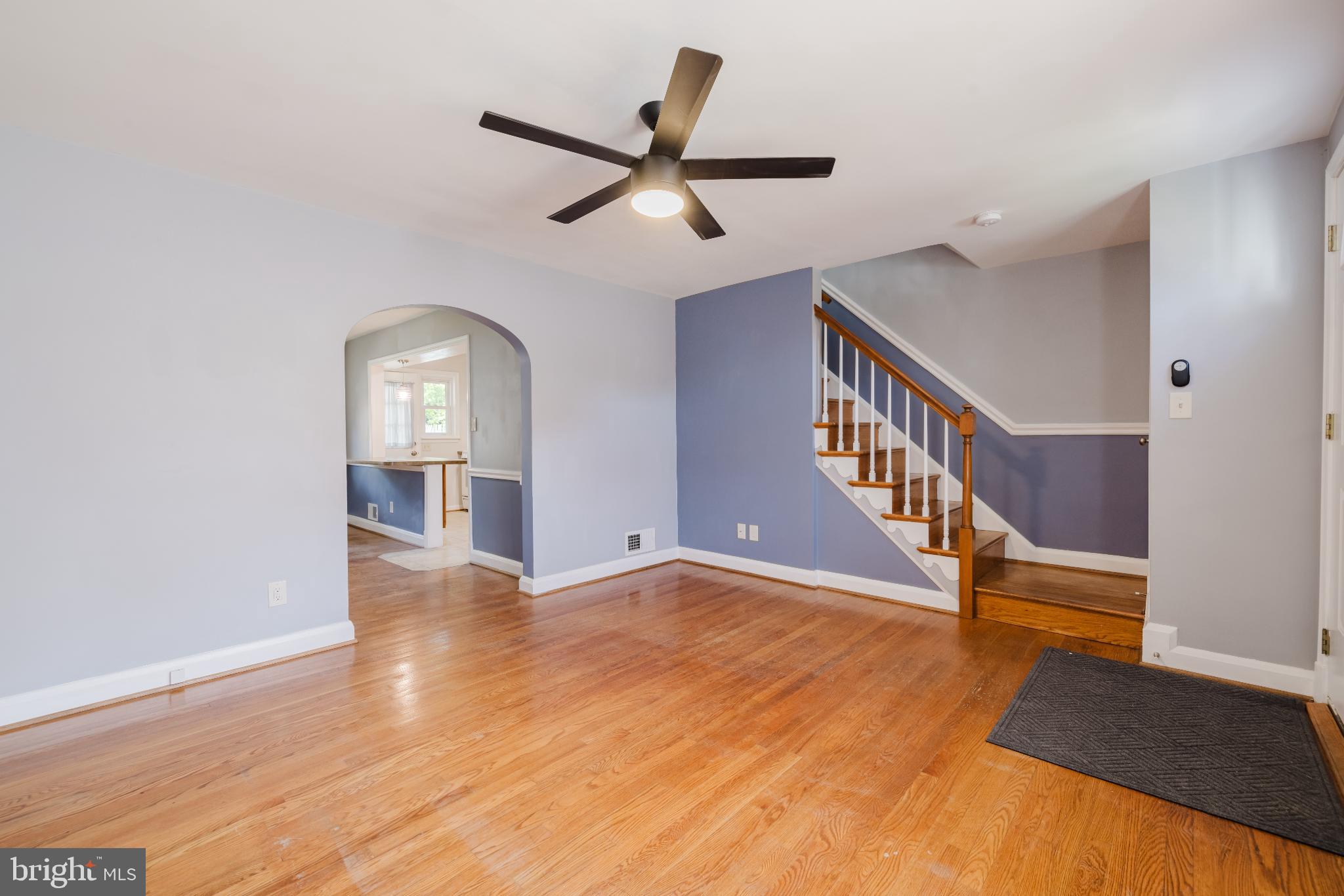 1636 Thetford Road Baltimore, MD 21286 - Photo 6 of 23 a view of an empty room with wooden floor and a ceiling fan