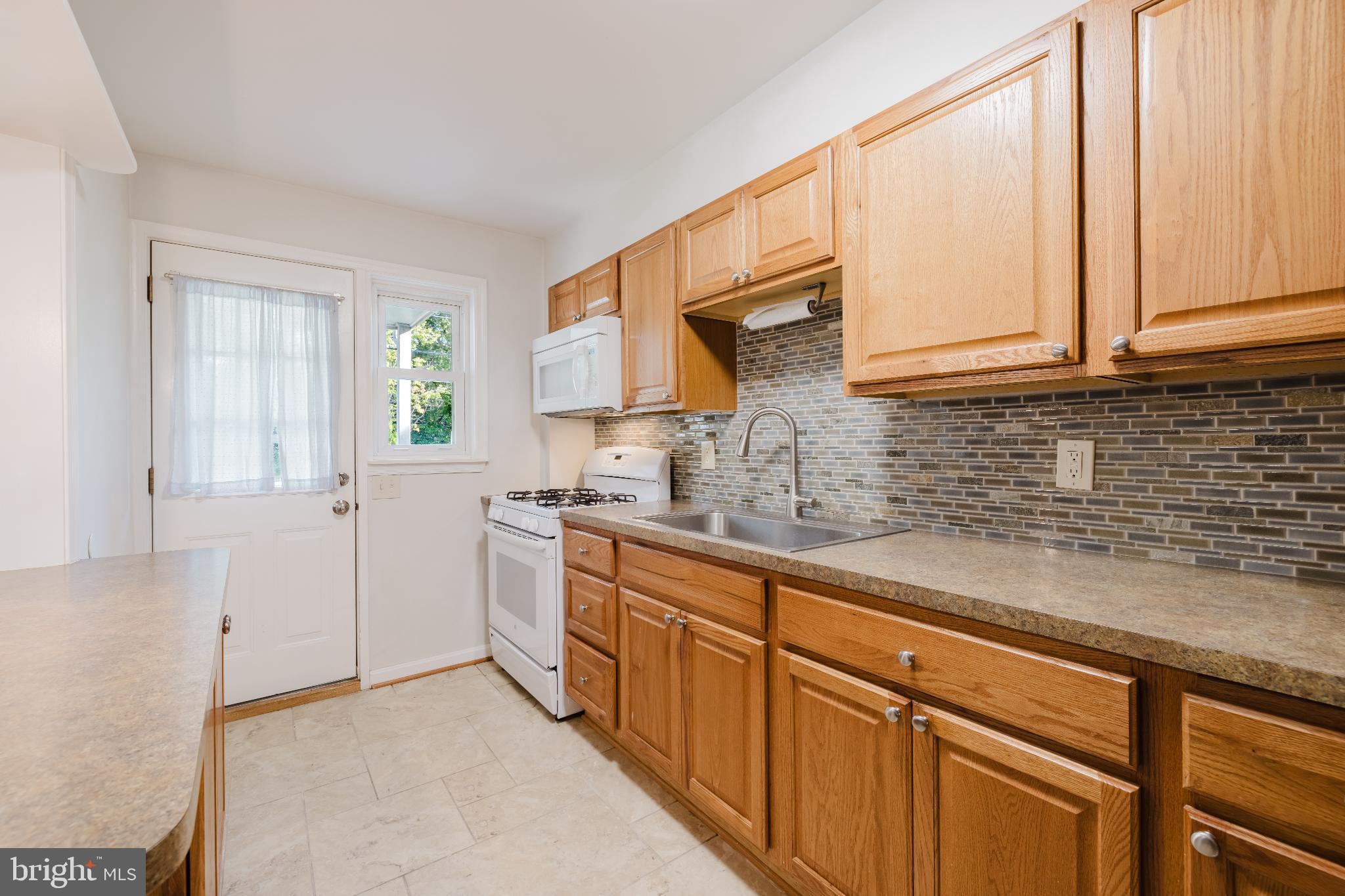 1636 Thetford Road Baltimore, MD 21286 - Photo 9 of 23 a kitchen with stainless steel appliances white cabinets and a sink