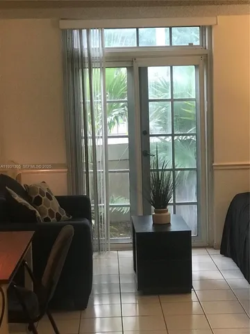 a close view of a sink and dishwasher with kitchen island white cabinets
