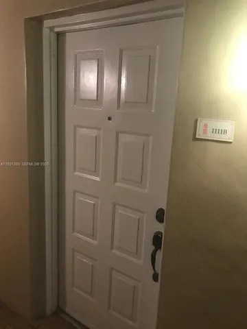 a kitchen with granite countertop a sink cabinets and stainless steel appliances