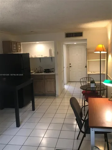 a balcony with furniture and a potted plant