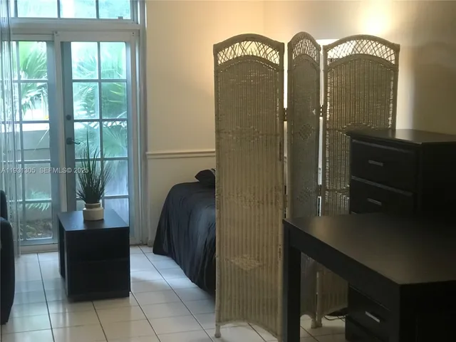 a view of a workspace with furniture and chandelier