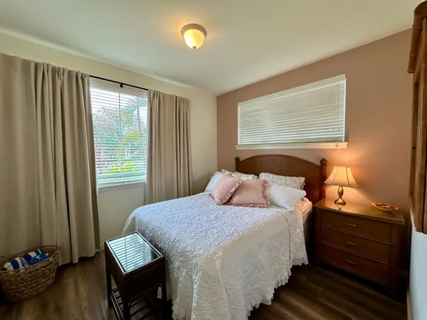 a bedroom with bed and wooden floor