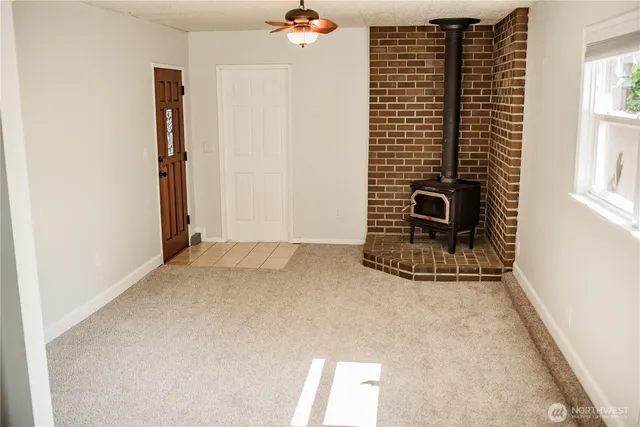 an empty room with wooden floor and a window
