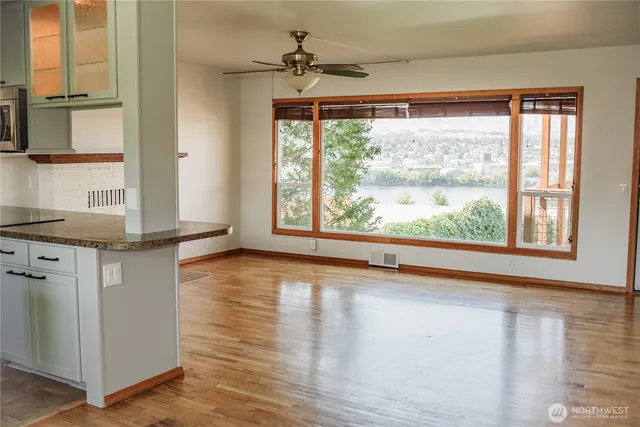 a view of a livingroom with wooden floor and a window