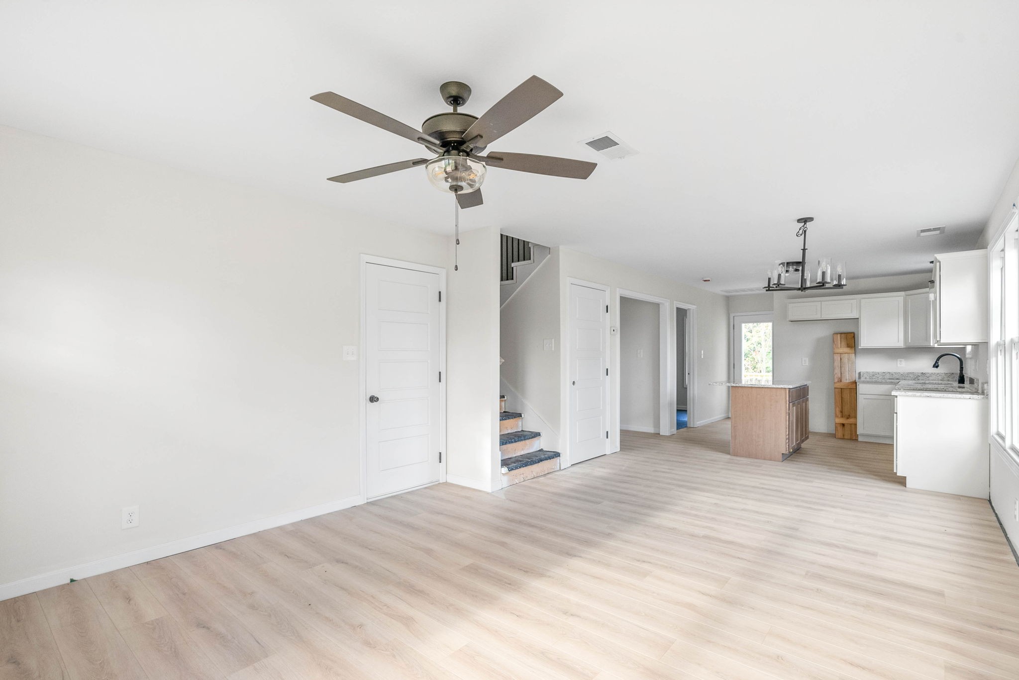 238 Wayne Hall Road Clarksville, TN 37040 - Photo 6 of 26 a view of a kitchen with wooden floor and a ceiling fan