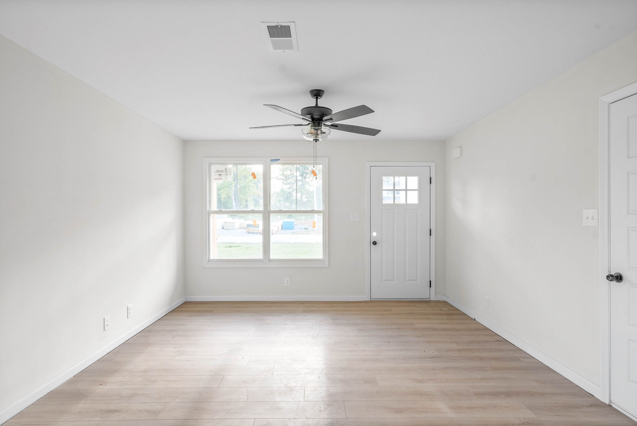 238 Wayne Hall Road Clarksville, TN 37040 - Photo 7 of 26 wooden floor in an empty room with a window