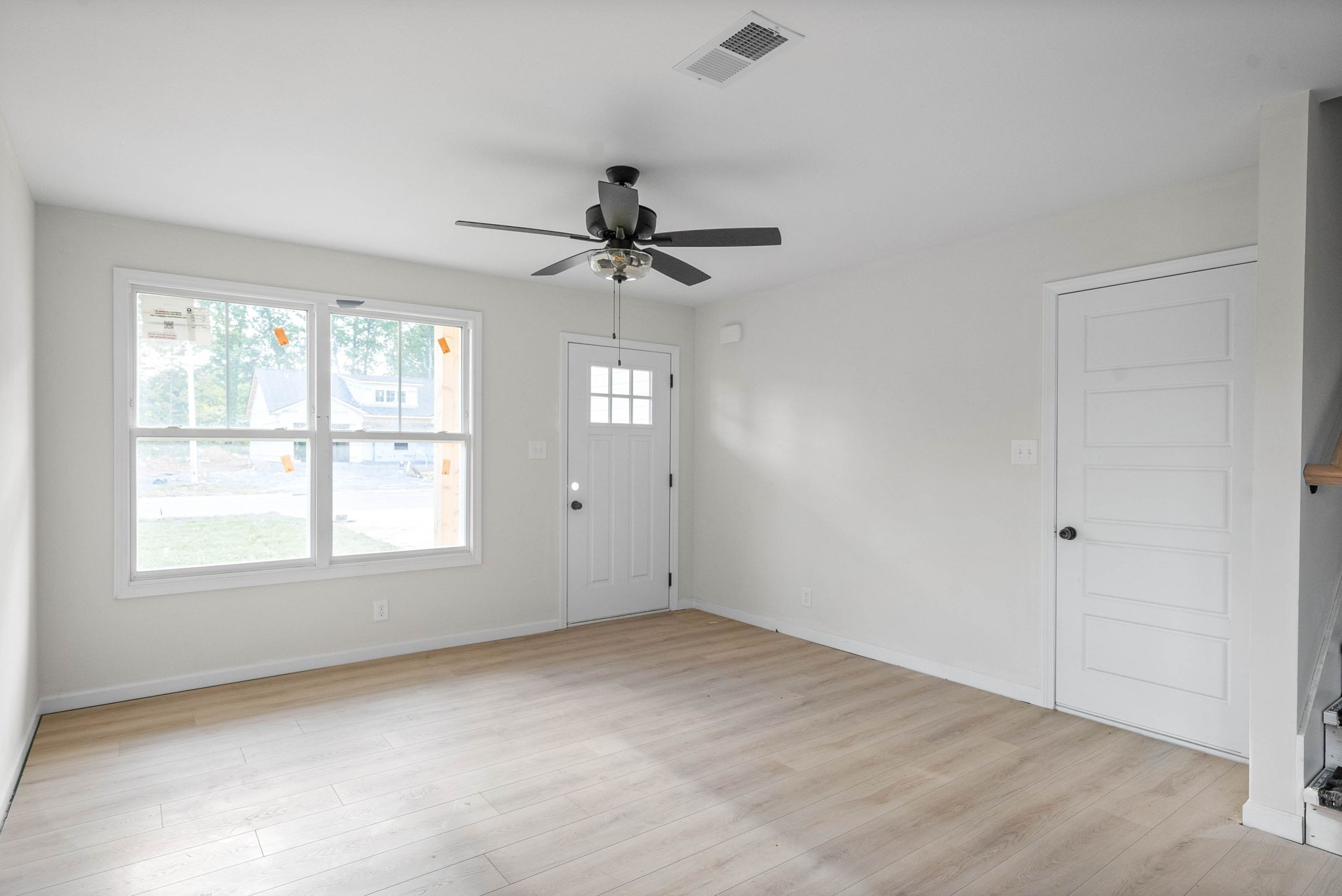 238 Wayne Hall Road Clarksville, TN 37040 - Photo 8 of 26 an empty room with chandelier fan and windows