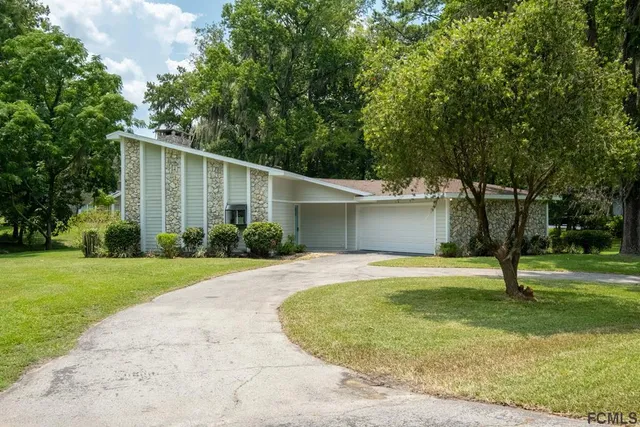 a house view with a backyard space