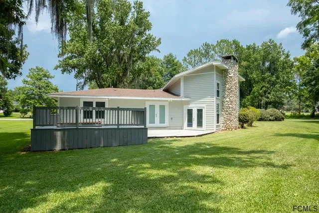 a house view with a sitting space and garden