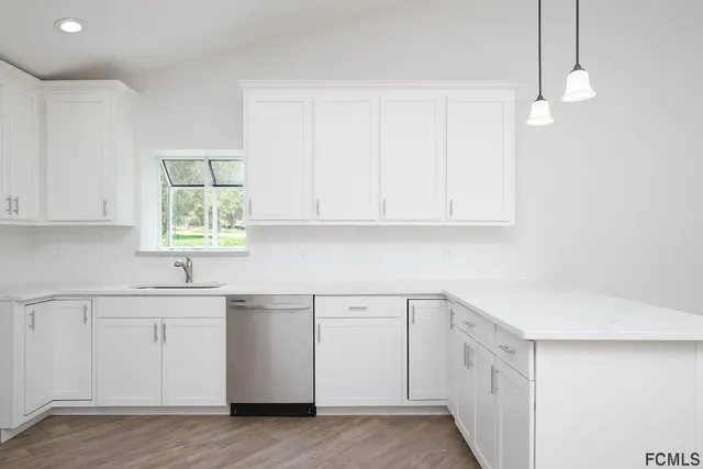 a kitchen with a sink cabinets and window