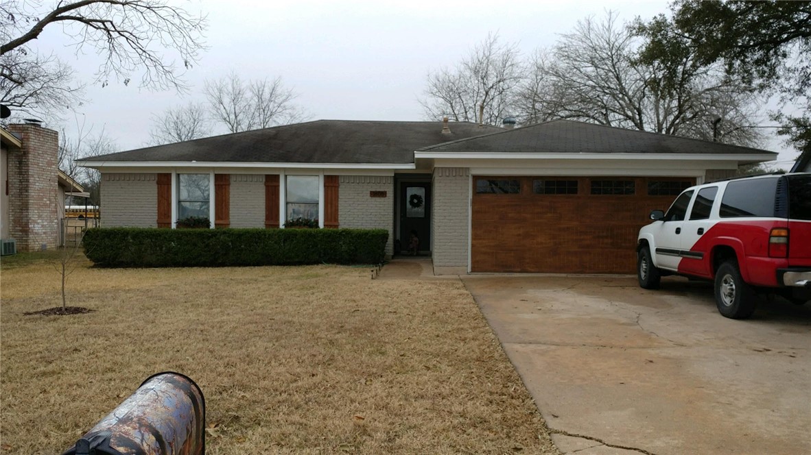 a couple of cars parked in front of a house