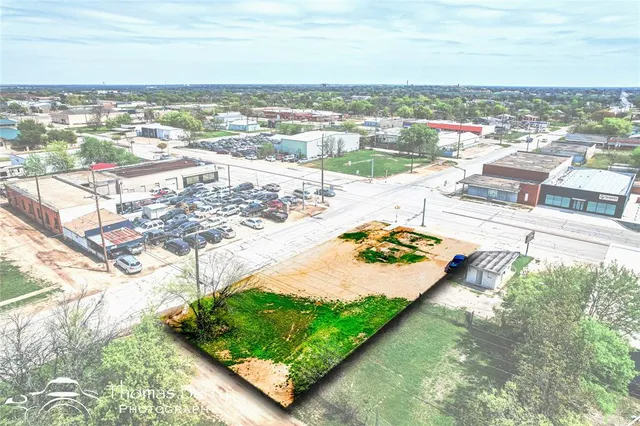 an aerial view of a house with a garden and lake view