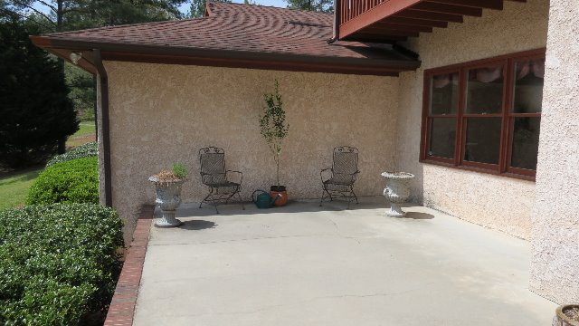 1143 Klopfer Road Macon, GA 31210 - Photo 18 of 19 a backyard of a house with potted plants and a bench