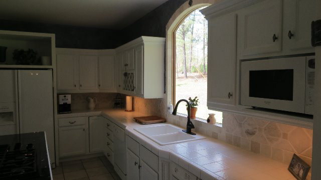 1143 Klopfer Road Macon, GA 31210 - Photo 9 of 19 a kitchen with a sink cabinets and window