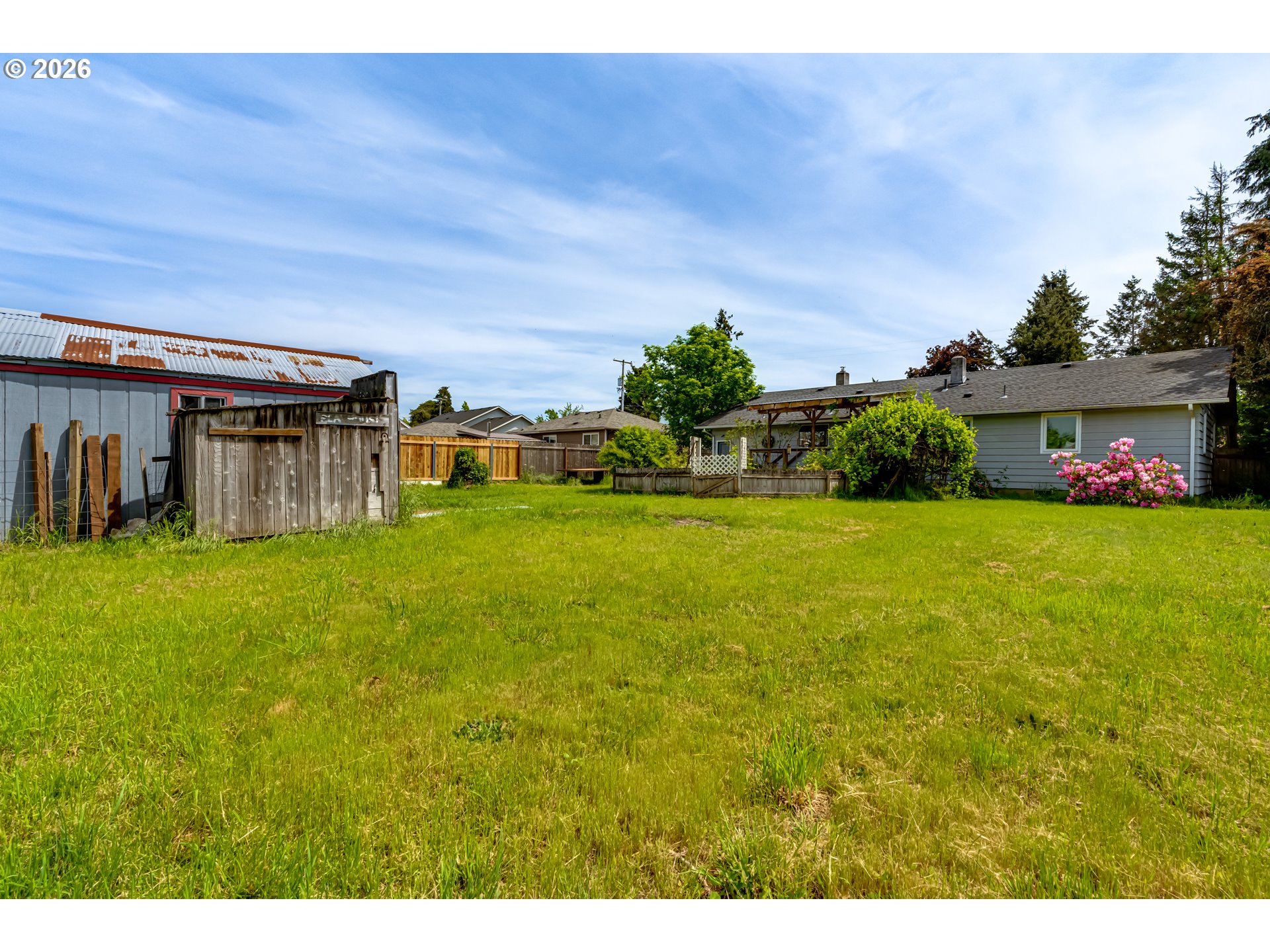 4076 North Street Springfield, OR 97478 - Photo 19 of 21 a view of a house with a big yard potted plants and large tree