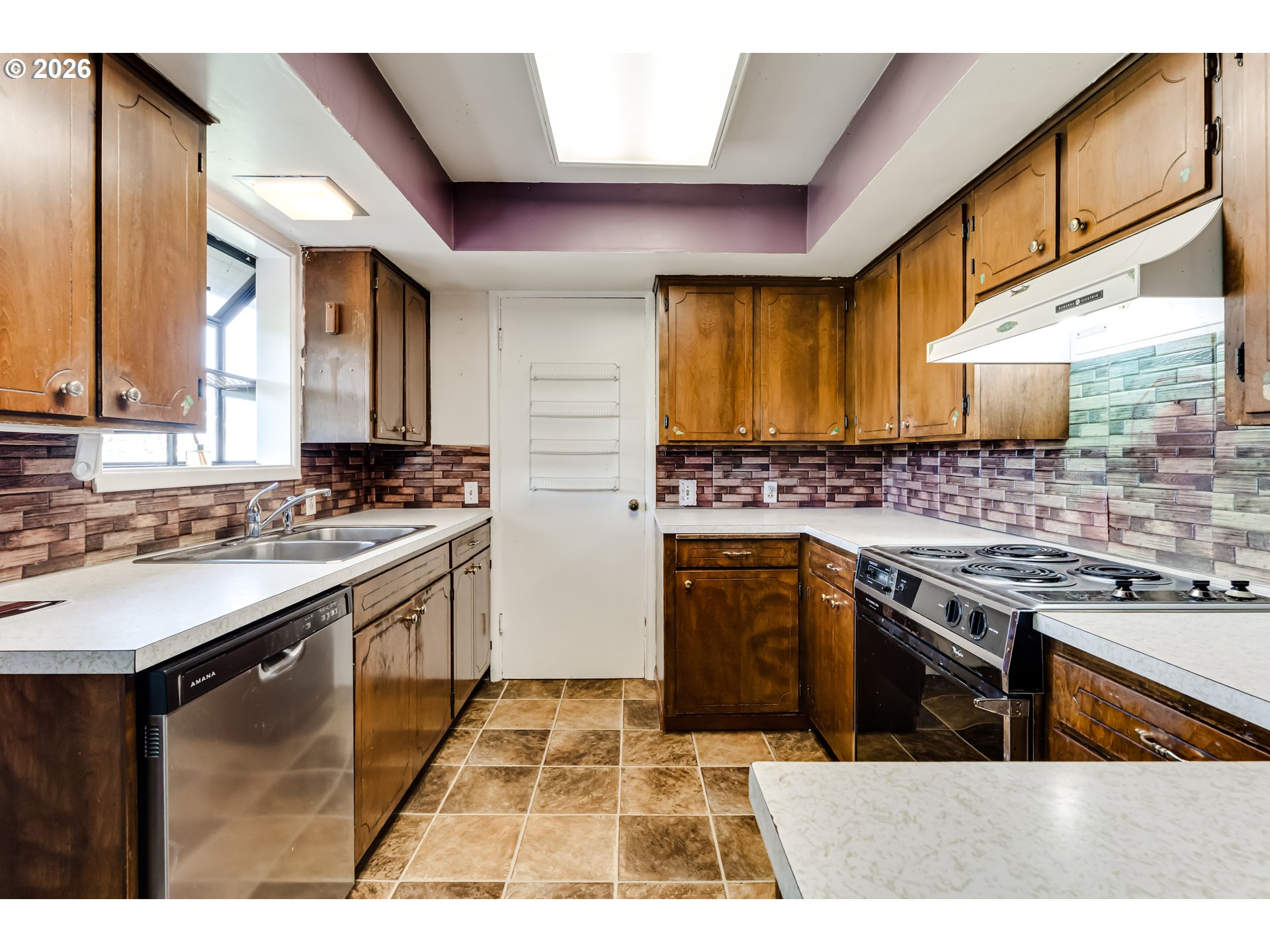 4076 North Street Springfield, OR 97478 - Photo 8 of 21 a kitchen with stainless steel appliances granite countertop a stove a sink dishwasher and cabinets with wooden floor