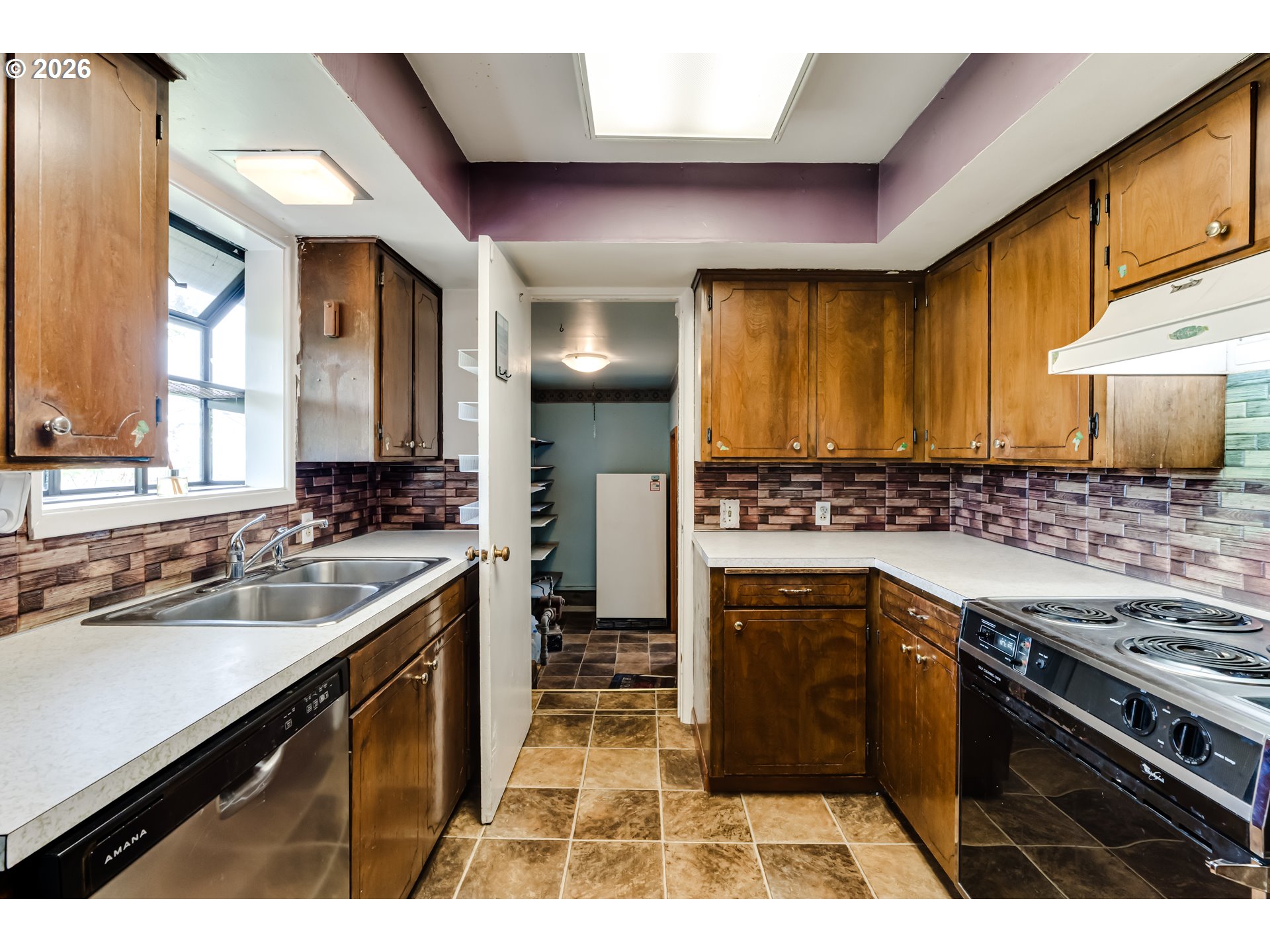 4076 North Street Springfield, OR 97478 - Photo 10 of 21 a kitchen with a sink stove top oven and cabinets