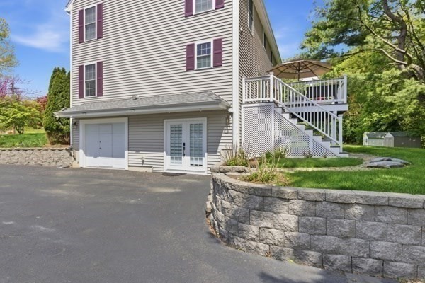 3 Wing Road Wilmington, MA 01887 - Photo 34 of 36 a front view of a house with a garden and plants