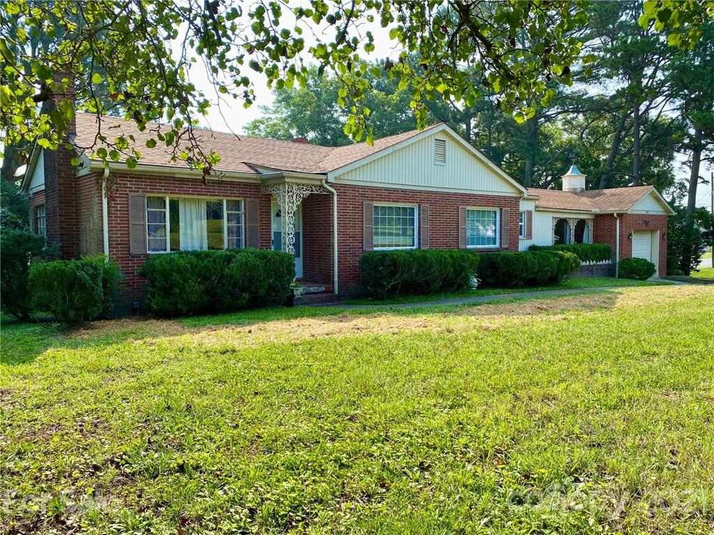 8930 Cool Springs Road Woodleaf, NC 27054 - Photo 1 of 42 a front view of a house with garden
