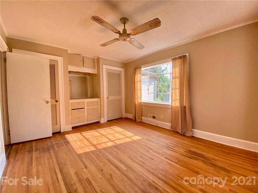 8930 Cool Springs Road Woodleaf, NC 27054 - Photo 11 of 42 a view of a livingroom with wooden floor a ceiling fan and windows