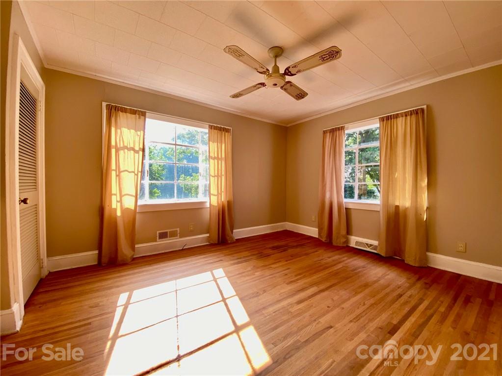 8930 Cool Springs Road Woodleaf, NC 27054 - Photo 12 of 42 a view of an empty room with a window and wooden floor