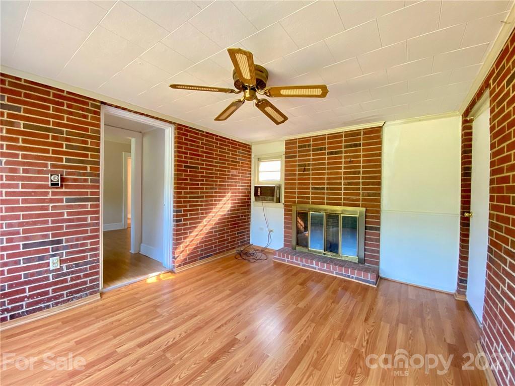 8930 Cool Springs Road Woodleaf, NC 27054 - Photo 13 of 42 a view of a livingroom with wooden floor and a ceiling fan