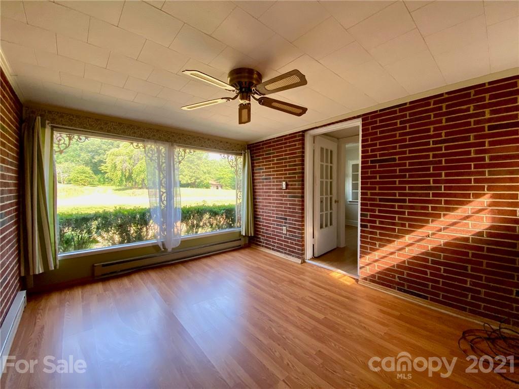 8930 Cool Springs Road Woodleaf, NC 27054 - Photo 14 of 42 a view of a livingroom with wooden floor and a ceiling fan