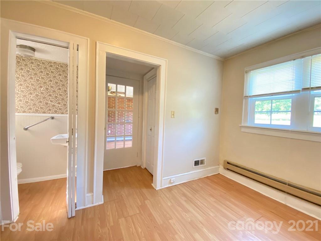 8930 Cool Springs Road Woodleaf, NC 27054 - Photo 18 of 42 a view of empty room with wooden floor and fan