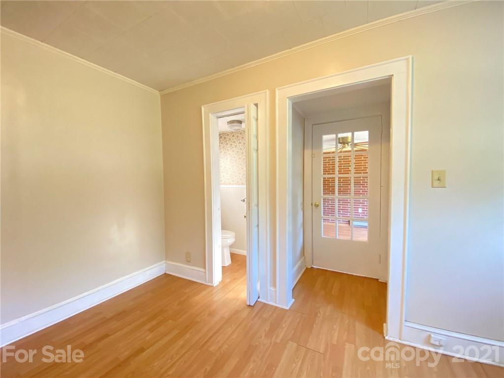 8930 Cool Springs Road Woodleaf, NC 27054 - Photo 19 of 42 an empty room with wooden floor and windows