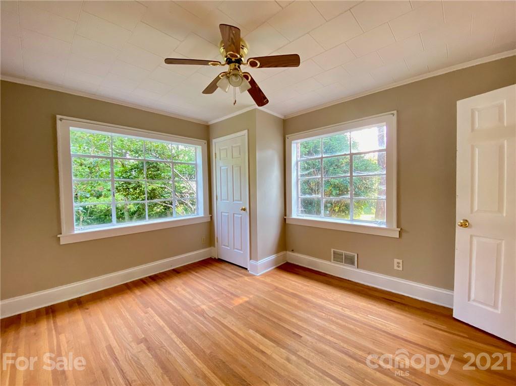 8930 Cool Springs Road Woodleaf, NC 27054 - Photo 20 of 42 a view of an empty room with wooden floor and a window