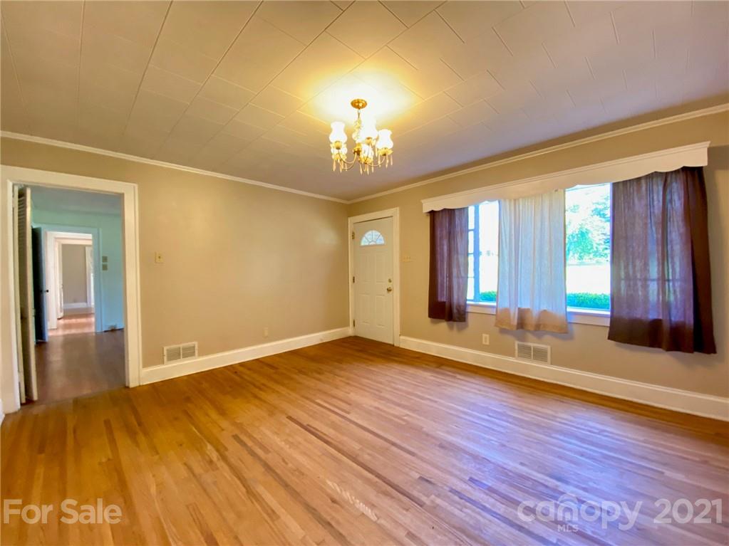 8930 Cool Springs Road Woodleaf, NC 27054 - Photo 3 of 42 a view of an empty room with wooden floor and a window